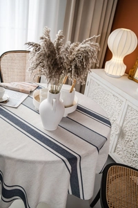 Macro view of navy striped linen round tablecloth with premium natural texture and drape