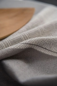 Macro shot of grey geometric jacquard fabric featuring Greek key and diamond patterns