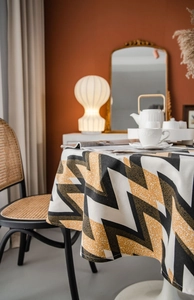Detailed view of bohemian tablecloth with gold and black geometric wave patterns
