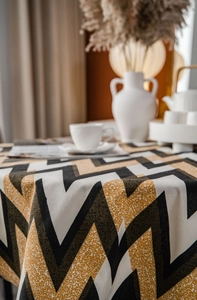 Detail of bohemian geometric zigzag tablecloth with natural textured linen fabric