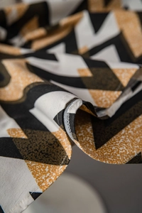 Close-up of bohemian golden ripple geometric pattern with professional edge stitching detail