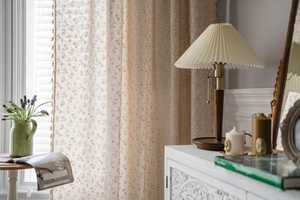 Detailed macro of pastoral cotton linen curtain with floral daisy print and tassel edge