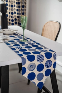 Close-up of geometric blue and white patterned table runner with modern dot prints