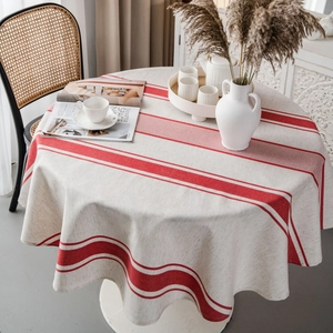 Runde beige Leinentischdecke mit roten Streifen in einer gemütlichen Retro-Atmosphäre