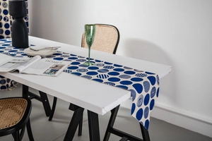 Close-up of modern blue geometric dots and stripes print on a premium fabric table runner