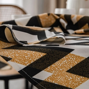 Bohemian geometric round tablecloth with black, white, and gold zig-zag textured patterns