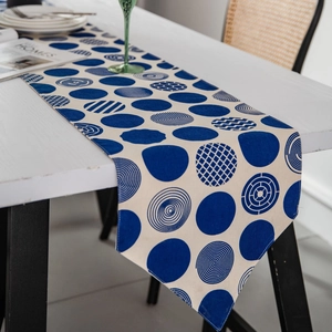 Modern blue geometric polka dot table runner on a white table with minimalist nordic style