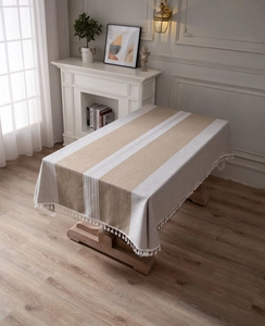 Detail view of cotton linen striped tablecloth with lace trim and tassel fringe