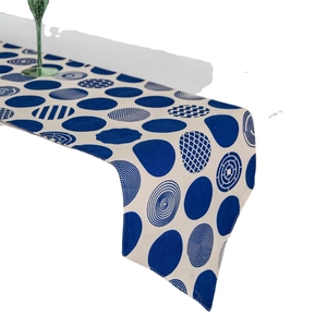 Modern Nordic table runner with blue and white geometric polka dot print in linen fabric