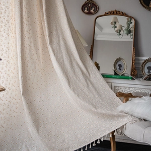 Linen cotton daisy print curtains with fringe trim in French retro style home setting