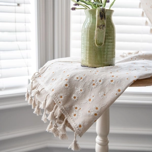 Cotton linen table runner with white daisy embroidery and decorative fringe tassels