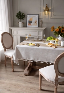 Detail of faux linen tablecloth featuring white tassels and matching bohemian runner