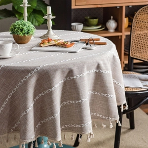 Round linen tablecloth with white leaf embroidery and fringe tassels for dining decor