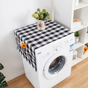 Detail view of black and white plaid washing machine cover with side storage pockets