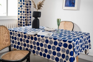 Detail of blue geometric dot print on rectangular linen tablecloth in minimalist home setting
