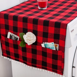 Detail showing red and black buffalo plaid dust cover with pom-poms and side pockets