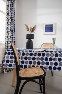 Detail view of navy blue geometric circle print tablecloth in a modern home setting