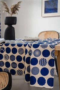 Detail of navy blue geometric polka dot table runner on a wooden dining table
