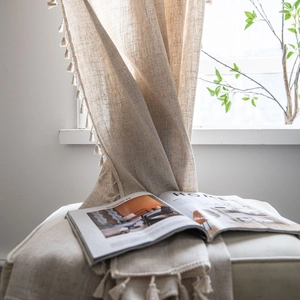Linen texture semi-blackout curtain with elegant tassel trim in beige neutral color