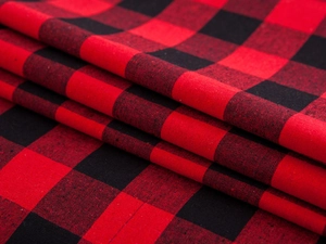 Close-up of red and black buffalo plaid fabric with soft texture and textile weave