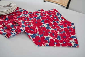 Macro detail of Chinese festive table runner with vibrant red floral and blue leaf prints