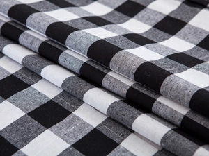 Detailed view of black and white checkered cotton linen fabric with a textured weave