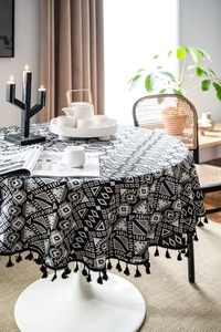 Detail of Nordic geometric table cloth with black fringe and ethnic tribal pattern