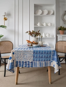 Detail of blue and white geometric patchwork cotton linen tablecloth on wooden table