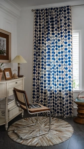 Detailed blue geometric dot pattern on linen curtain with delicate fringe trim accents