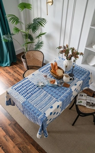 Detail view of blue geometric patchwork cotton linen tablecloth on a dining table