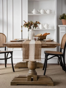 Macro detail of brown and beige woven cotton linen table runner with tassel fringe texture