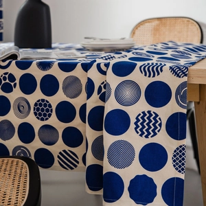Modern cotton linen tablecloth featuring navy blue geometric dot prints on wood table