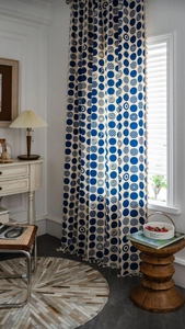 Detail of bohemian blue polka dot pattern on linen curtains for kitchen window