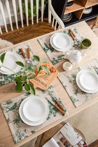 Detail of pine cone pattern on cotton linen table placemat with vintage forest print