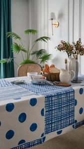 Detailed view of blue geometric hand-painted patterns on thick linen tablecloth fabric