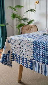 Detail of blue geometric print tablecloth on cotton linen fabric for modern dining room