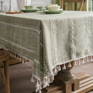 Green cotton linen tablecloth with white embroidery and elegant tassel edges