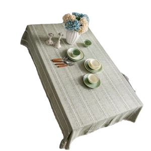 Sage green rectangular linen tablecloth with vertical white embroidery and stripes