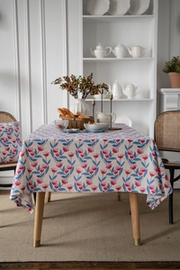 Detailed texture of cotton linen floral tablecloth with pink tulip print in a home setting