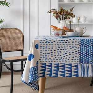 Blue geometric print linen tablecloth with modern patterns on a minimalist dining table