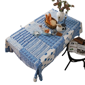 Blue and white geometric linen tablecloth with Nordic patterns on a dining table