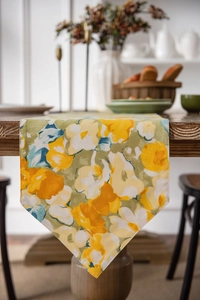 Detail of pastoral table runner with yellow floral print and elegant pointed corner design