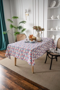 Detail of floral rectangular tablecloth featuring red flower and blue leaf patterns