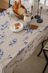 Detailed view of blue floral bee pattern on vintage style cotton linen tablecloth