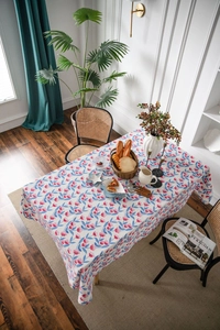 Detailed view of pastoral cotton linen tablecloth with pink floral and blue leaf patterns