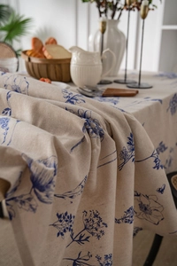 Macro shot of cotton linen tablecloth showing blue floral print and weave texture