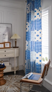 Detail eines Vorhangs im Boho-Stil mit blauem Geometrie-Druck und eleganten Quastenkanten
