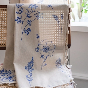 Beige linen curtains with blue flower and bee prints featuring white fringe tassels