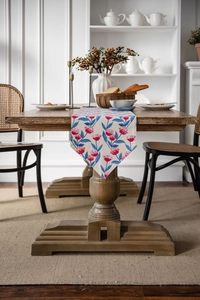 Close-up of pink flower and blue leaf print on off-white table runner fabric