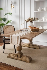 Detailed view of cream woven table runner with coffee stripes and handmade tassels